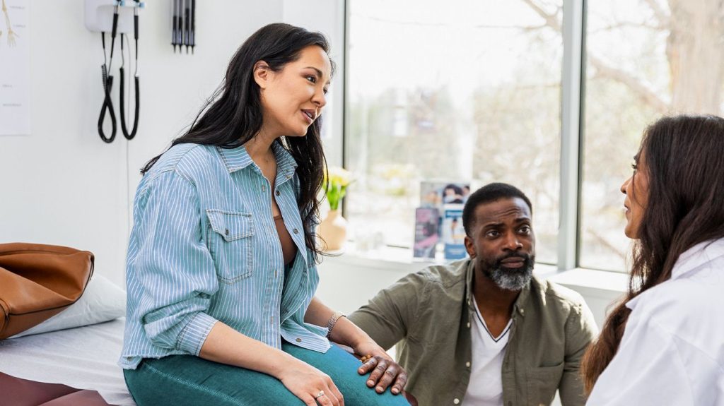 Patient and friend talking with doctor