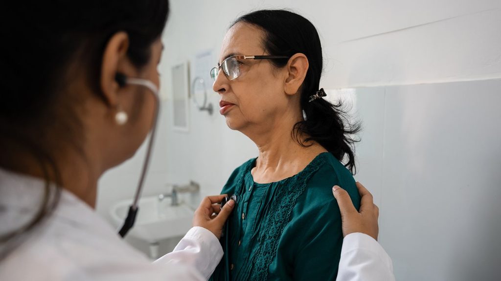 Doctor examining female patient