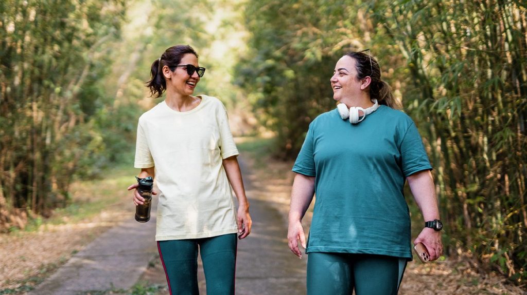 Female friends walking briskly outdoors