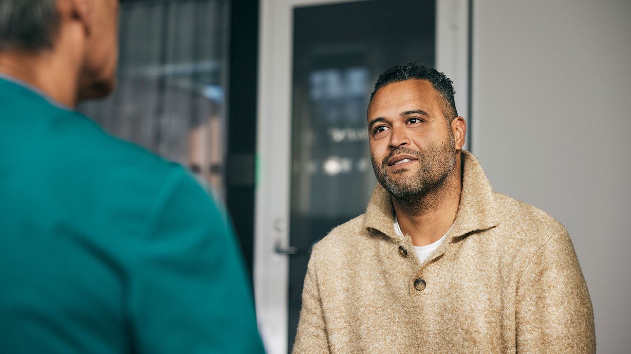 Male patient talking with doctor