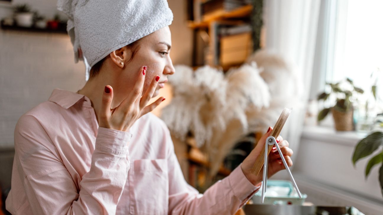 Young female applying baking soda to face