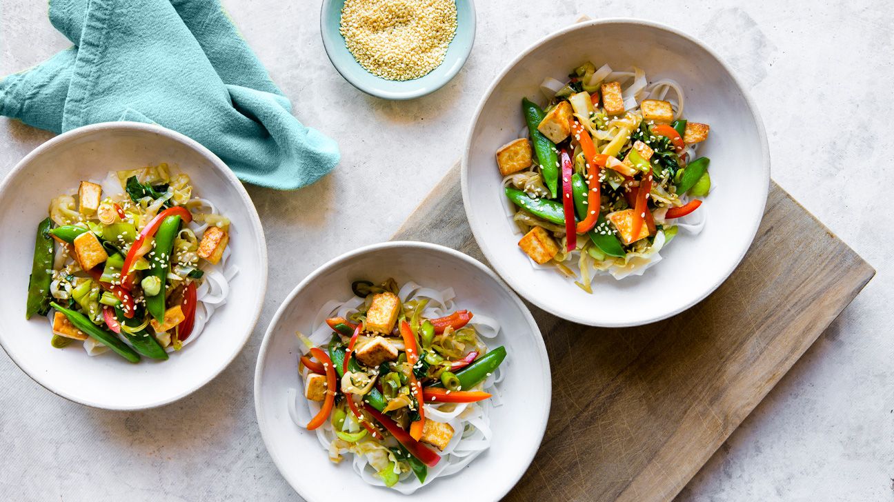Plant-based stir fry in white bowls