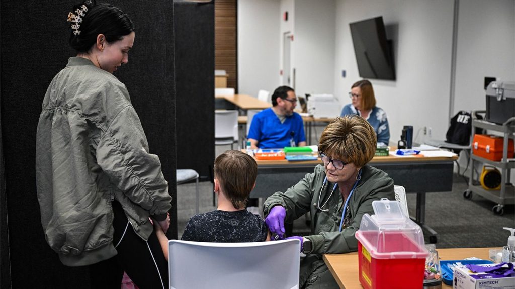 Child receives vaccine at clinic