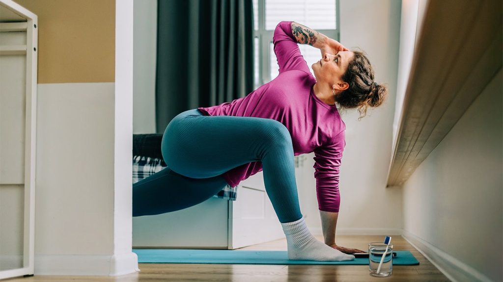 View through a doorway, showing a female doing yoga